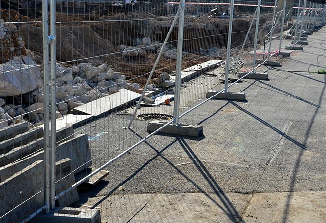 stack of temporary fence panels, ready to provide security to an outdoor event